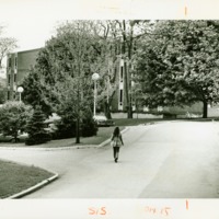 A female student walks towards Prosser Hall, ca. 1970s.