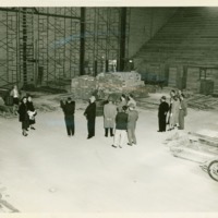 A small crowd of administrators and faculty gather within Memorial Hall during construction, ca. 1954.