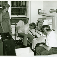 A student moves into a dorm room, ca. 1970s.