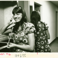 A student talks on a dormitory phone, ca. 1970s.