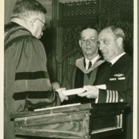 President Tyson handing Captain Canaga a diploma.