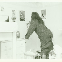 A student decorates her dorm room, ca. 1980s.